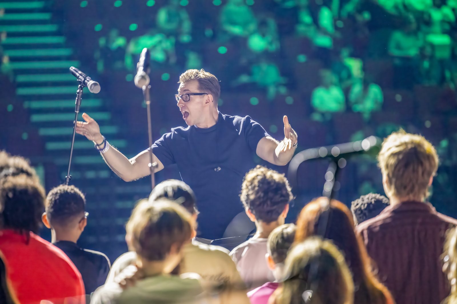 Craig Antony Lees directing a choir in rehearsal